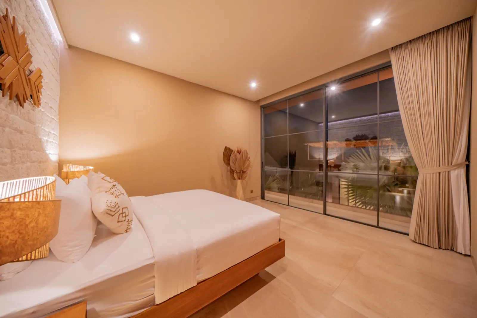 Bedroom two looking out to the lit pool at night, Villa Navaho, Bumbak Bali