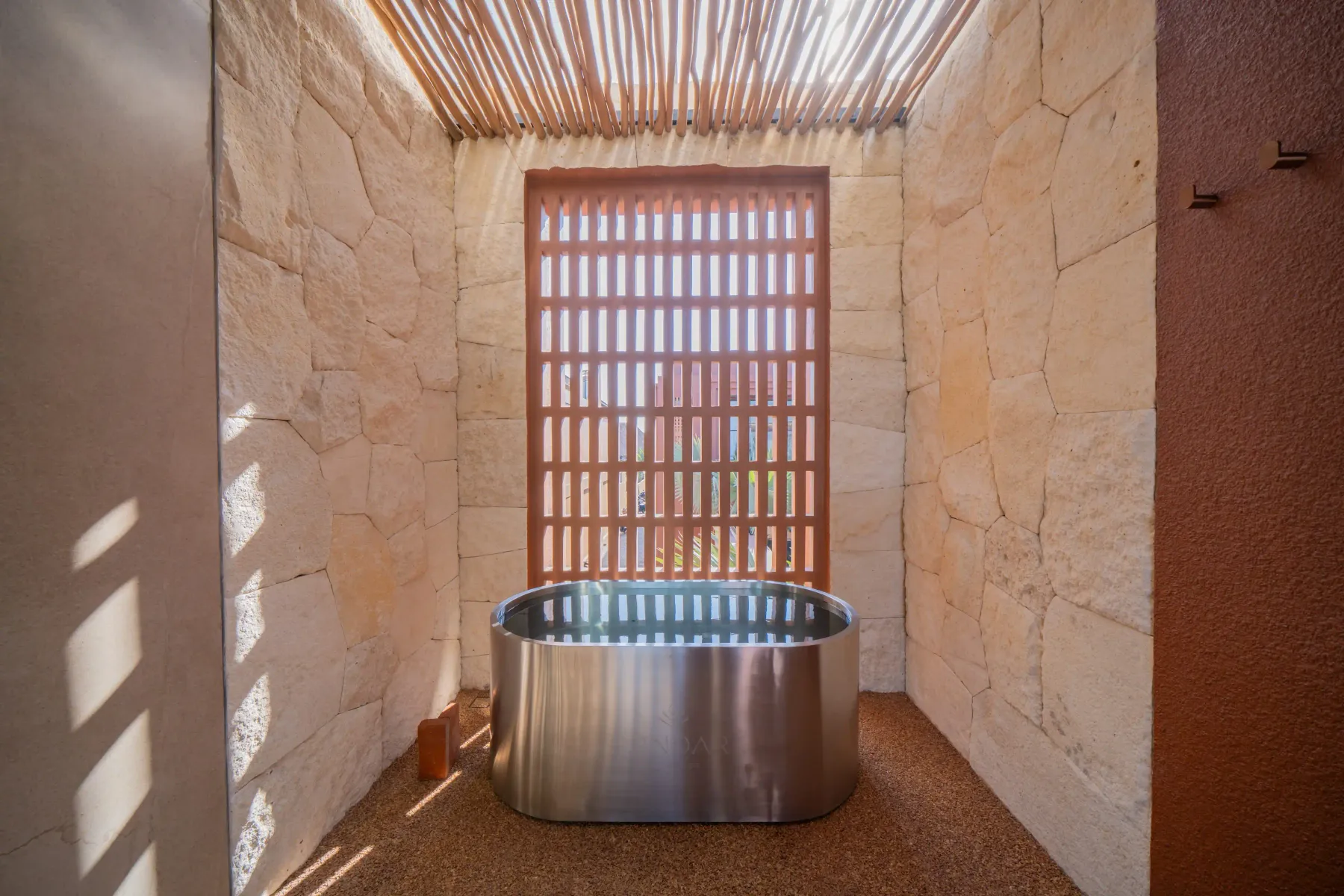 Cold plunge tub in a limestone courtyard open to the sky, Villa Navaho, Bumbak Bali