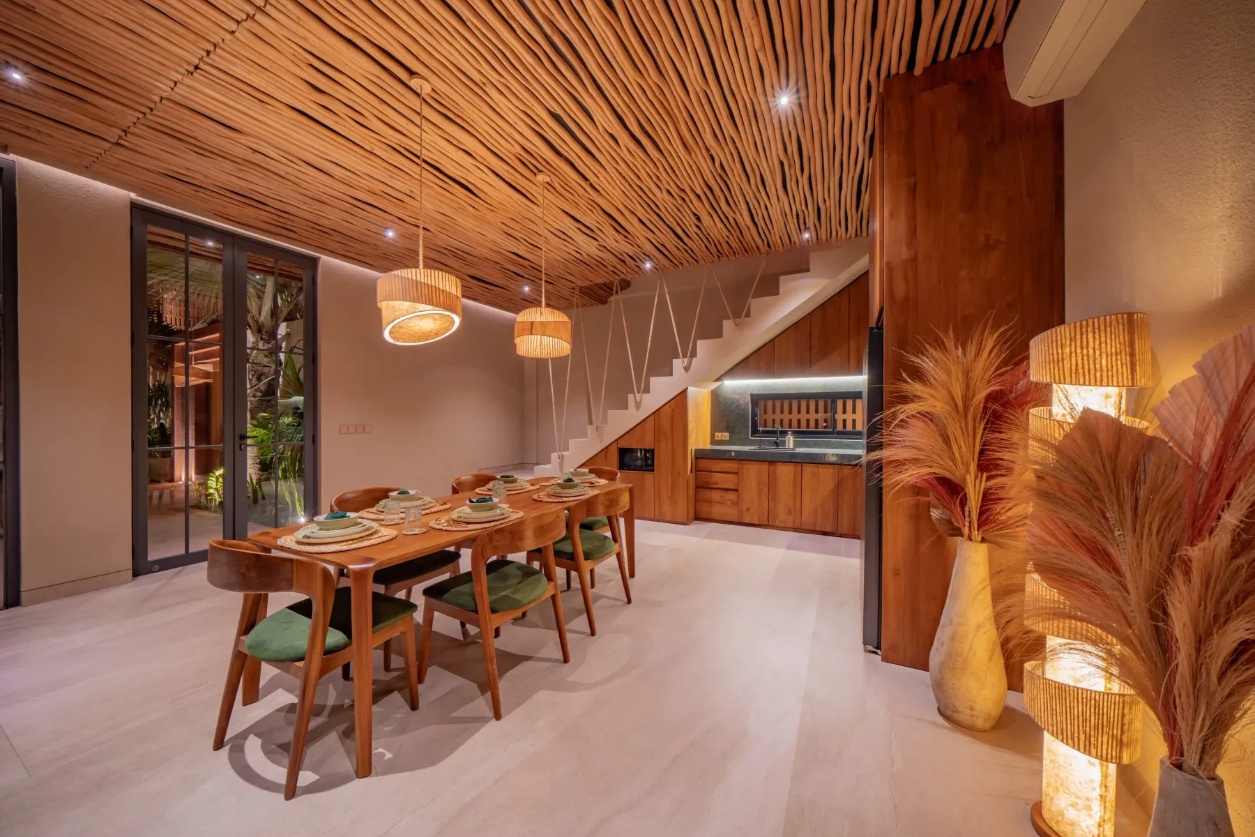 Dining table set for six beneath rattan pendants at Villa Navaho, Bumbak Bali