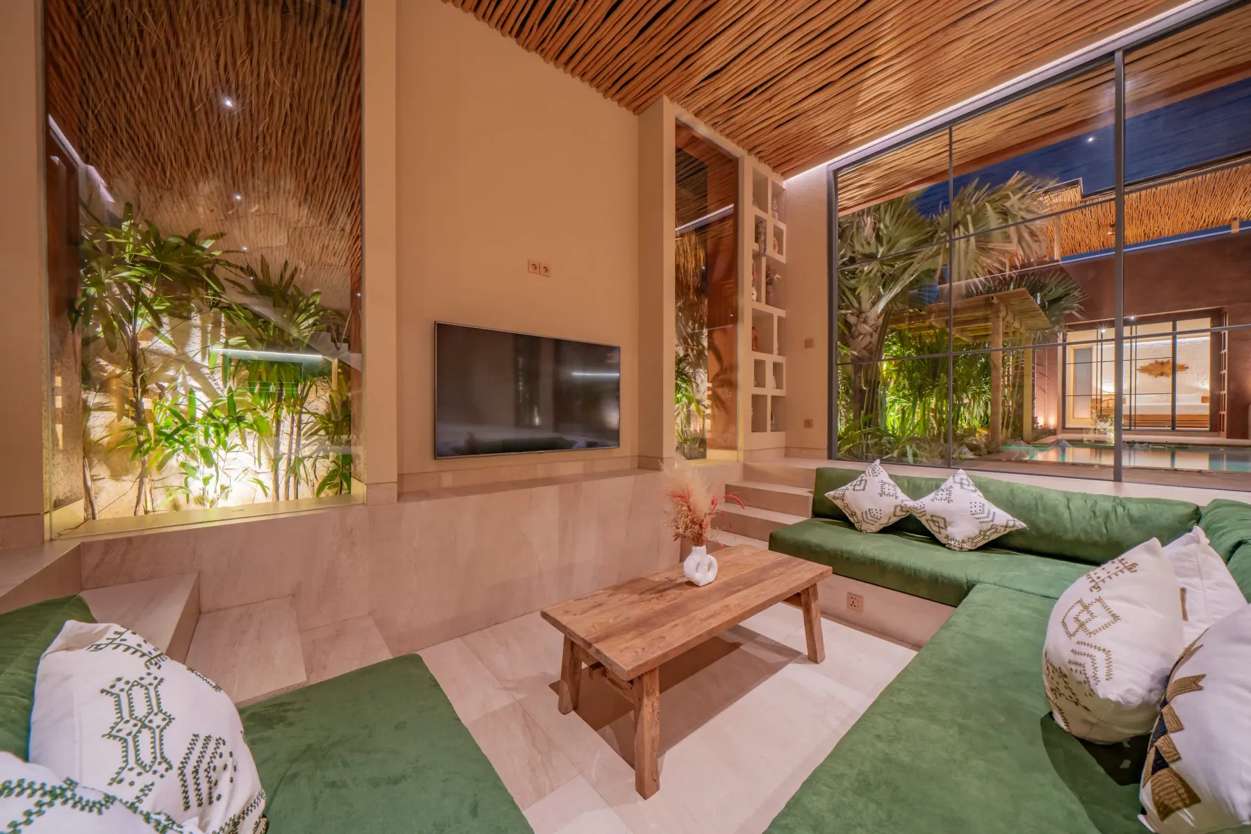 Low seating around a solid wood table in the living room at Villa Navaho