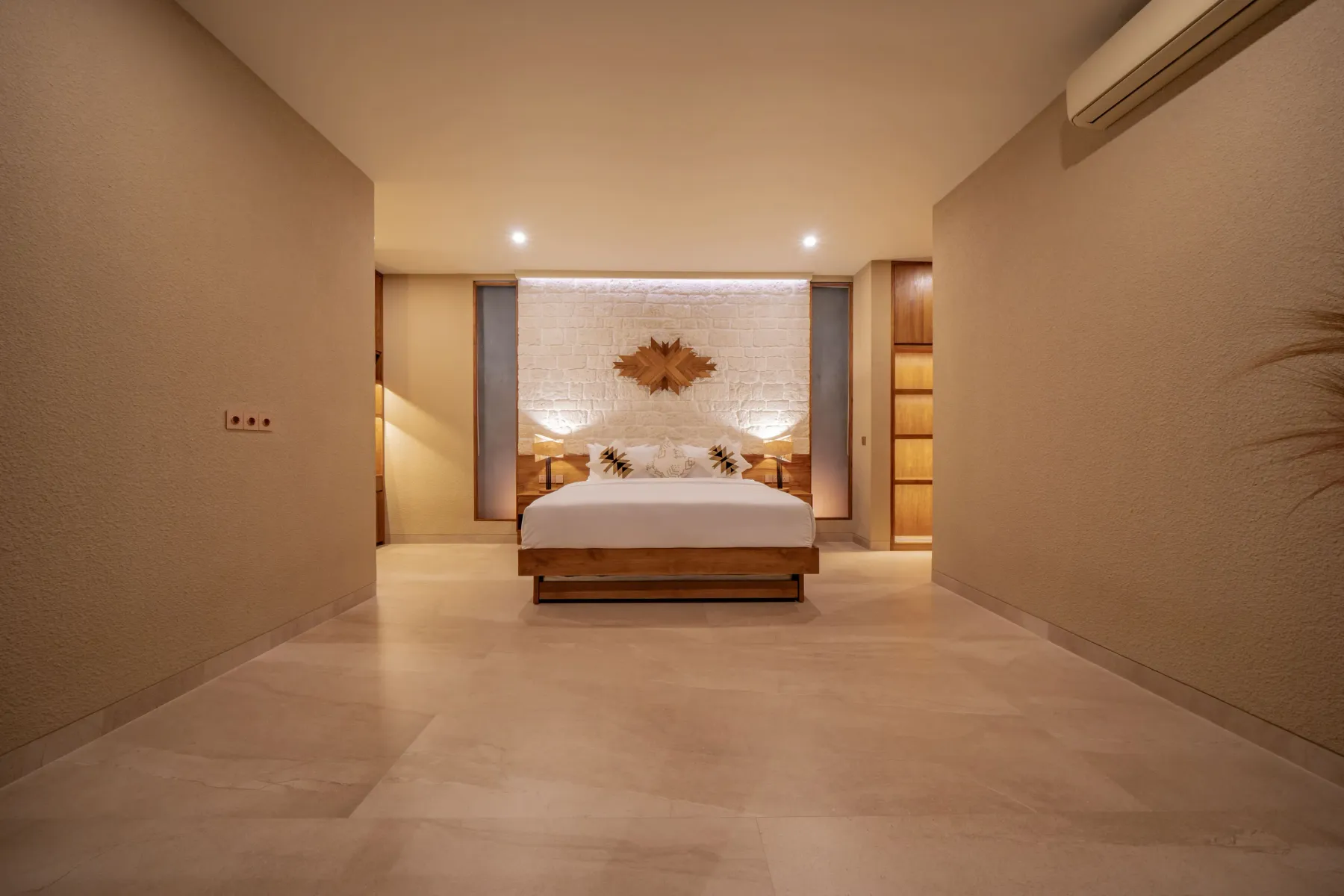 King bed against a whitewashed brick wall in the master bedroom at Villa Navaho
