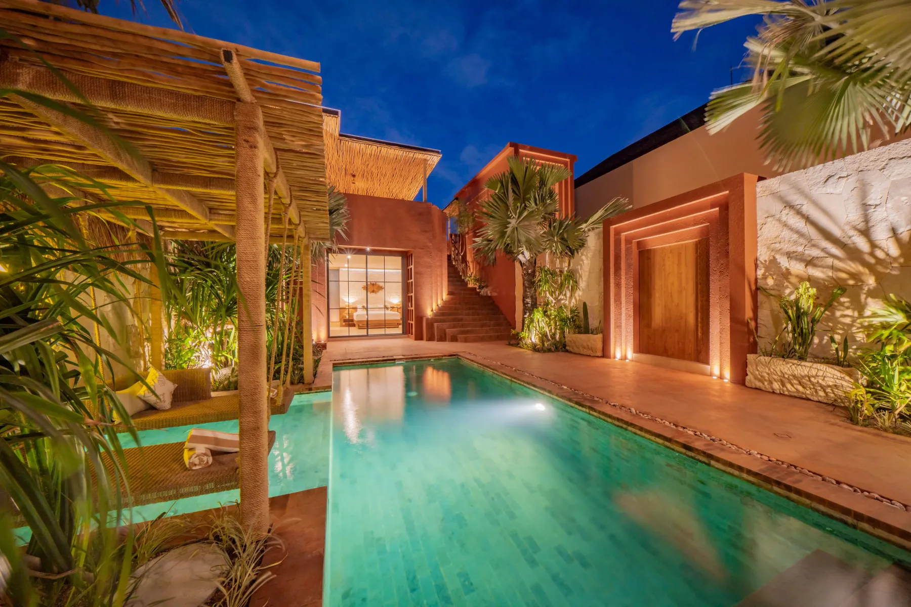 Private pool lit from the water at dusk, Villa Navaho, Bumbak Bali