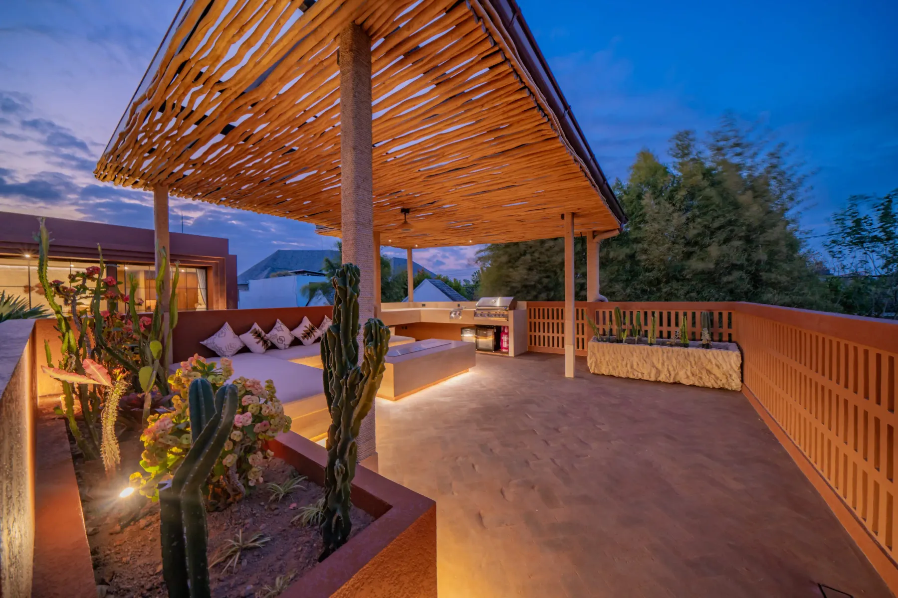 Rooftop deck under a bamboo canopy with cacti along the edge, Villa Navaho
