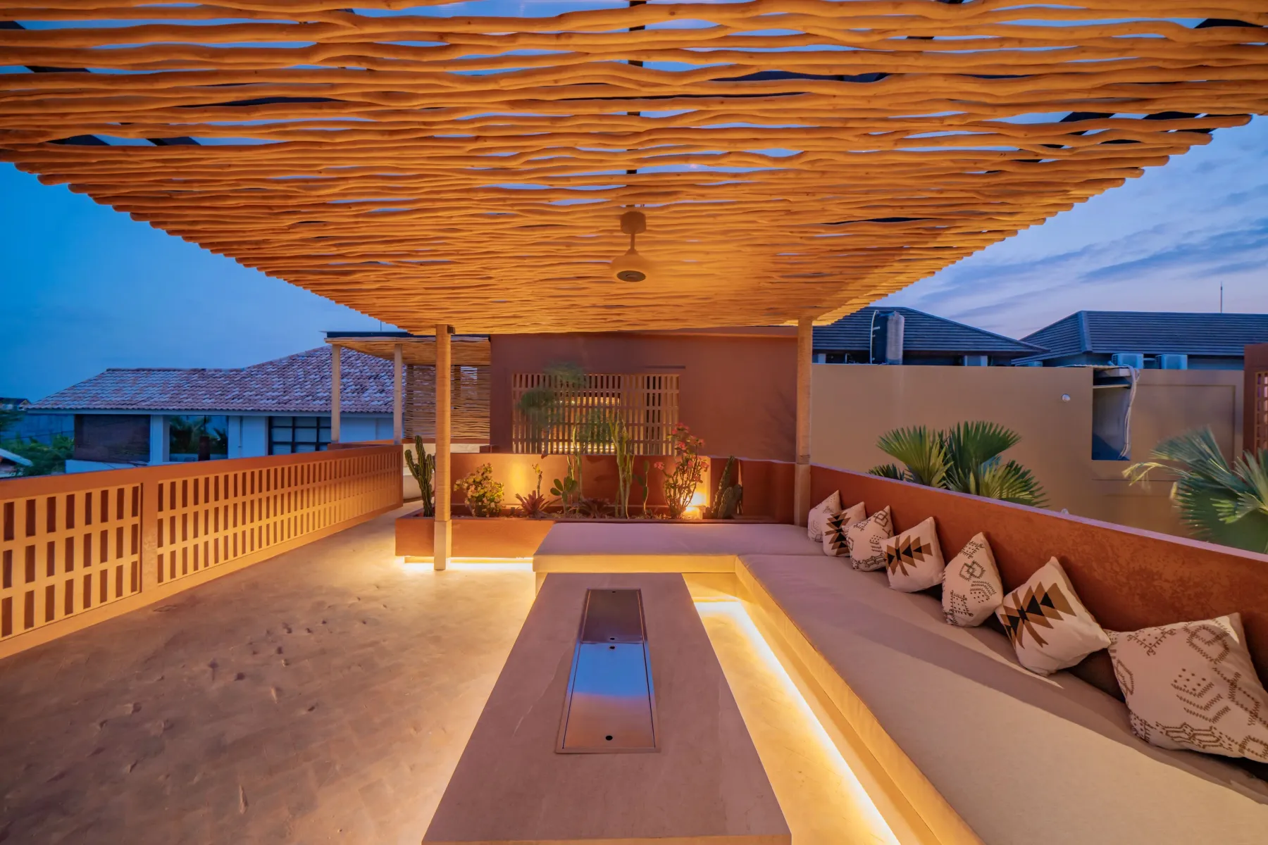 Looking along the rooftop deck out over the rooftops at dusk, Villa Navaho